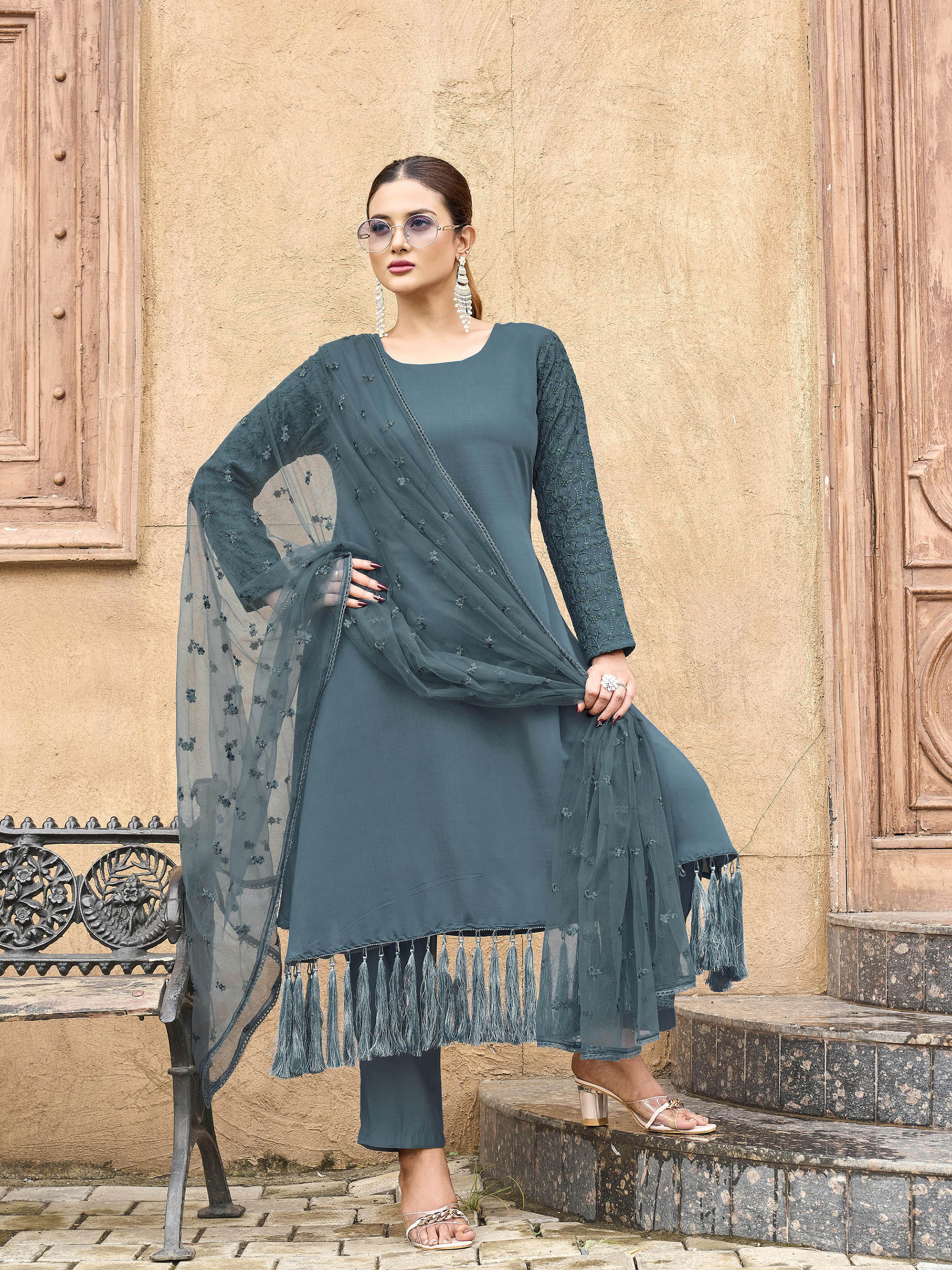 Burnt Blue color silk blend with thread embroidered on sleeves & tassels on heamline kurta & trouser with dupatta set